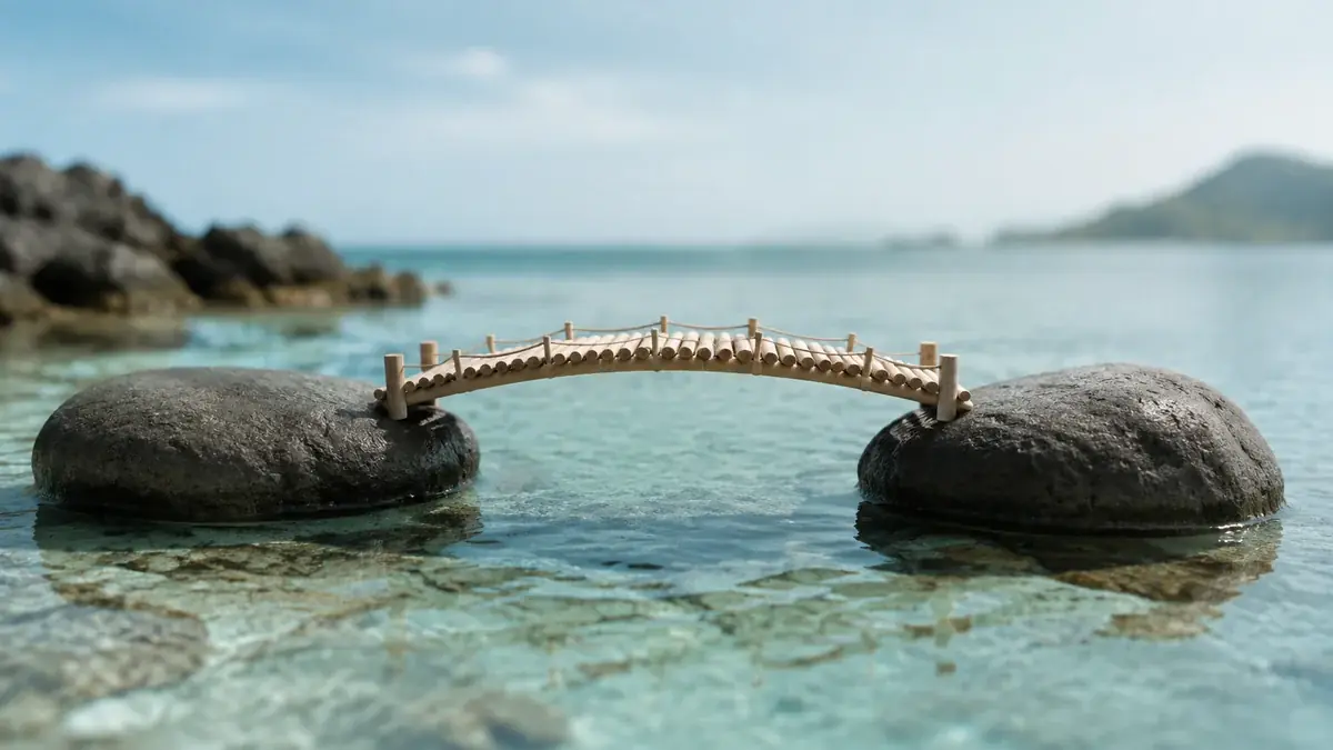 Local technology advice: two simple stones connected by a delicate wooden bridge over shallow turquoise water
